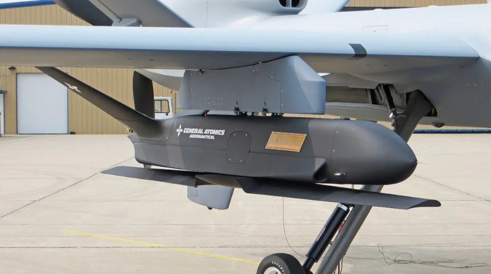 The General Atomics Sparrowhawk, which is designed to be both launched and recovered in mid-air, under the wing of an MQ-9. <em>GA-ASI</em>