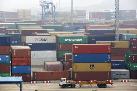 A trailer loaded with container boxes travels in Ningbo port in Zhejiang province, January 22, 2015. REUTERS/William Hong