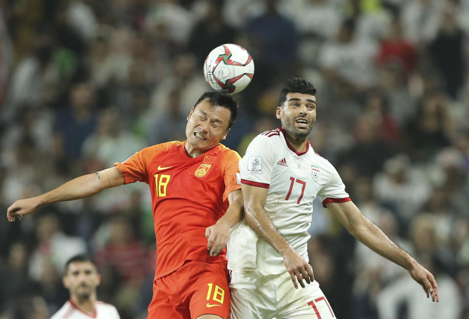 China's forward Gao Lin, left, and Iran's forward Mehdi Taremi fight for the ball during the AFC Asian Cup quarterfinal soccer match between Iran and China at Mohammed Bin Zayed Stadium in Abu Dhabi, United Arab Emirates, Thursday, Jan. 24, 2019. (AP Photo/Kamran Jebreili)