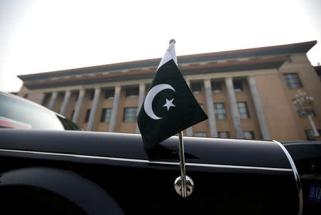 FILE PHOTO - A car with a Pakistani flag waits for Pakistani Minister Imran Khan outside the Great Hall of the People during his visit in Beijing, China, November 3, 2018. REUTERS/Jason Lee