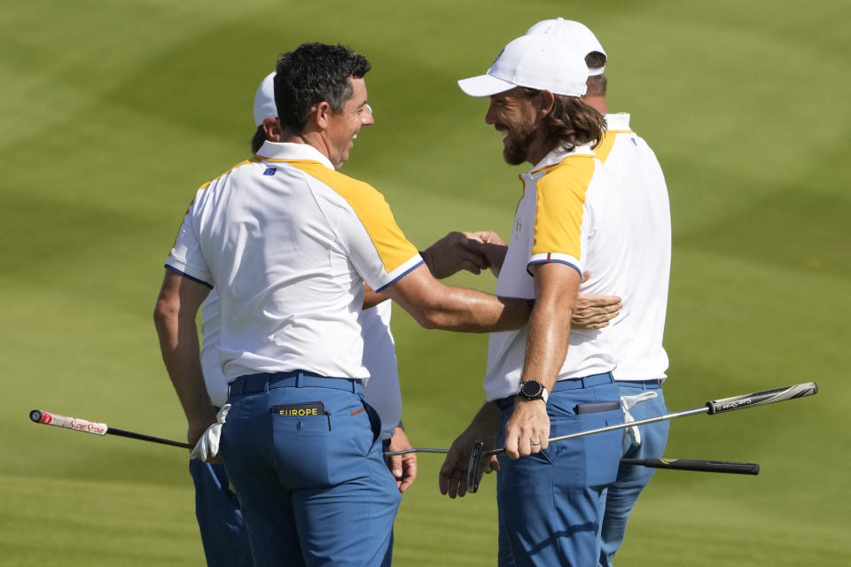 Europe's Rory Mcilroy, left shakes hands with Europe's Tommy Fleetwood after they completed a practice round ahed of the Ryder Cup at the Marco Simone Golf Club in Guidonia Montecelio, Italy, Tuesday, Sept. 26, 2023. The Ryder Cup starts Sept. 29, at the Marco Simone Golf Club. (AP Photo/Andrew Medichini)