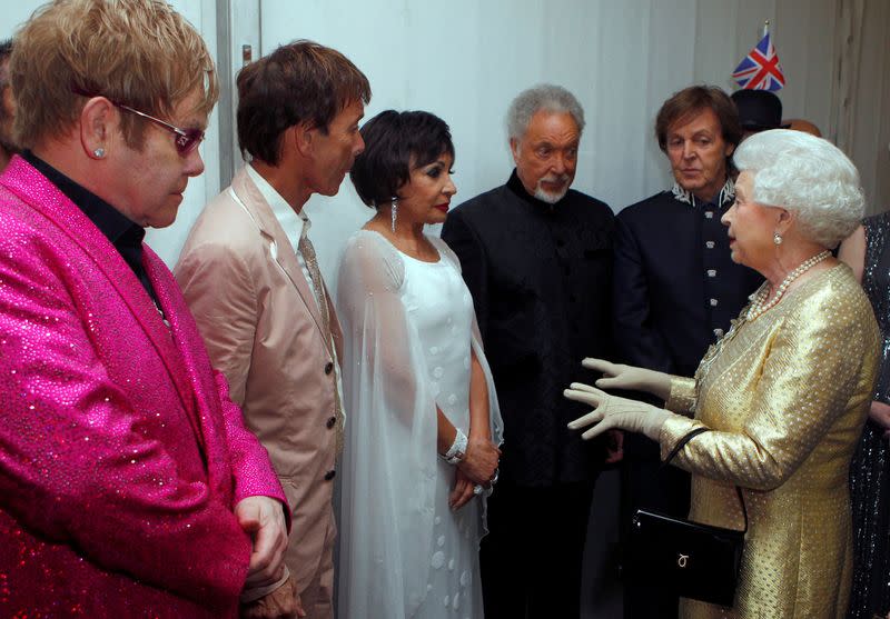 FILE PHOTO: Queen Elizabeth meets singers Elton John, Cliff Richard, Shirley Bassey, Tom Jones and Paul McCartney backstage at the Diamond Jubilee Concert outside Buckingham Palace in London