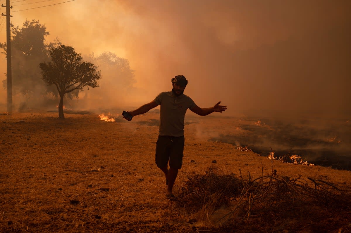 A man walks away from an advancing wildfire in Turkey in 2021, with Europe accounting for 8 per cent of reported deaths worldwide (AFP/Getty)