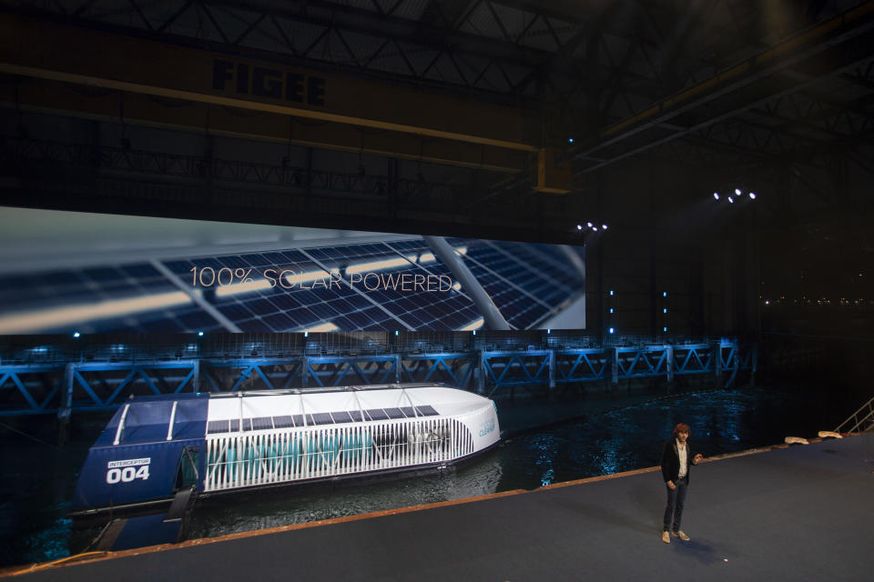 Young Dutch inventor Boyan Slat, right, unveils the Interceptor in Rotterdam, Netherlands, Saturday, Oct. 26, 2019. Slat is taking his effort to clean up floating plastic from the Pacific Ocean to rivers, using the Interceptor, a new floating device to catch garbage before it reaches the seas. (AP Photo/Peter Dejong)