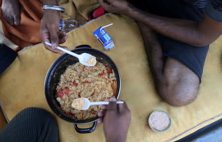 Migrants eat a meal in a makeshift tent camp in Velika Kladusa, Bosnia and Herzegovina, July 26, 2018. REUTERS/Dado Ruvic