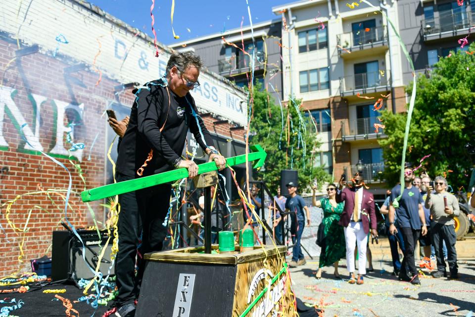 Streamers fly around Michael Grozier, founder and CEO of Trueline and co-founder of House of Blues, during a groundbreaking event for the new music venue in the West End in Greenville, S.C., on Thursday, April 25, 2024.