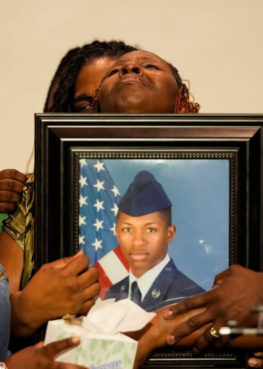 CORRECTS SERVICE BRANCH TO U.S. AIR FORCE INSTEAD OF U.S. NAVY – Chantemekki Fortson, mother of Roger Fortson, a U.S. Air Force senior airman, weeps as she holds a photo of her son during a news conference regarding his death, along with family and attorney Ben Crump, Thursday, May 9, 2024, in Fort Walton Beach, Fla. Fortson was shot and killed by police in his apartment, May 3, 2024. (AP Photo/Gerald Herbert)