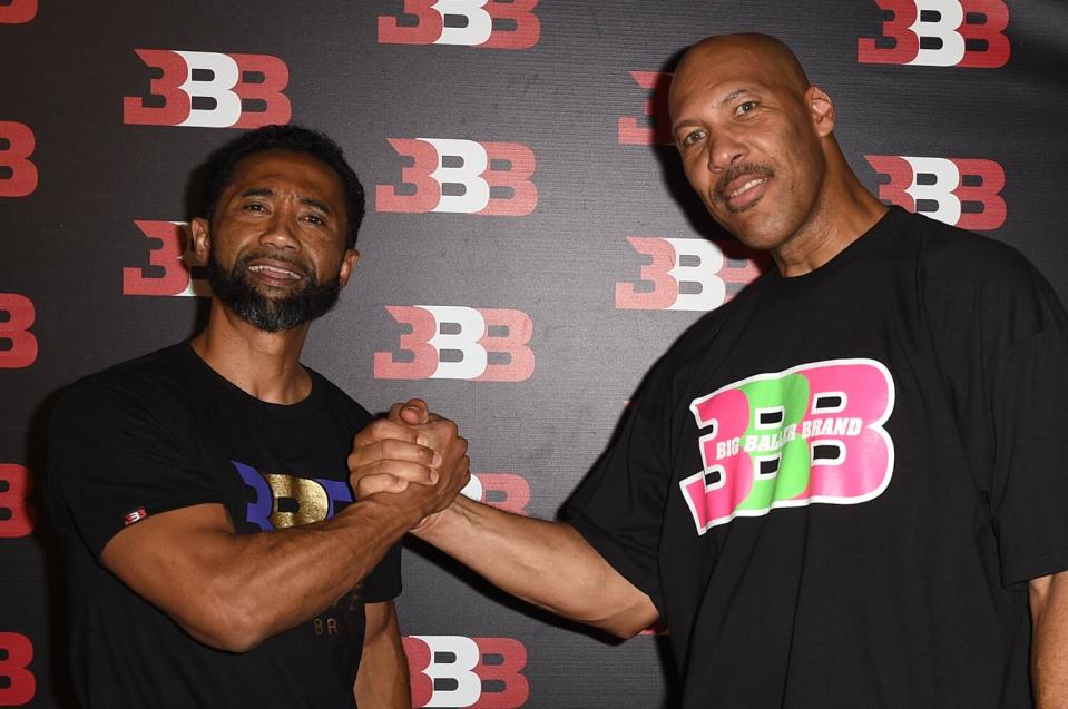 Alan Foster, left, and LaVar Ball shake hands at LaMelo Ball's 16th birthday party.