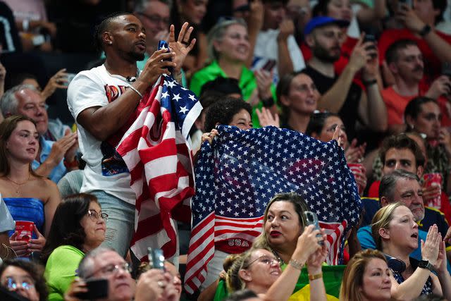 <p>Mike Egerton/PA Images via Getty </p> From Left: Jonathan Owens and Nellie Biles watching Simone Biles on July 30, 2024