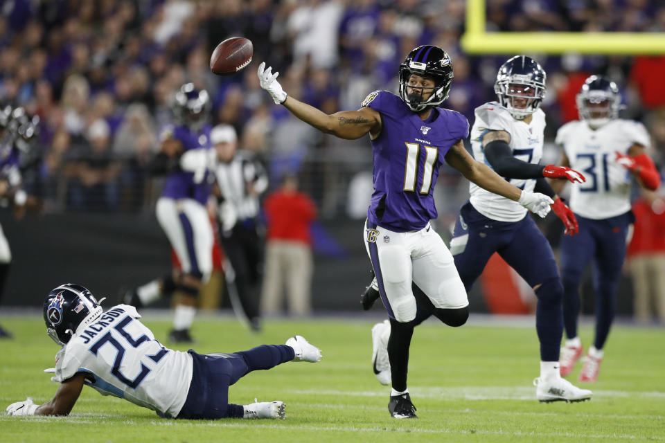 Baltimore Ravens wide receiver Seth Roberts (11) can't catch a pass as he is covered by Tennessee Titans strong safety Kenny Vaccaro (24) during the first half an NFL divisional playoff football game, Saturday, Jan. 11, 2020, in Baltimore. (AP Photo/Julio Cortez)