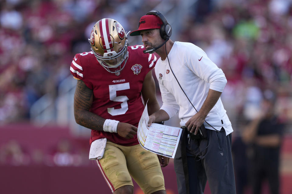 San Francisco 49ers head coach Kyle Shanahan, right, talks with quarterback Trey Lance during a game last season. (AP Photo/Tony Avelar)