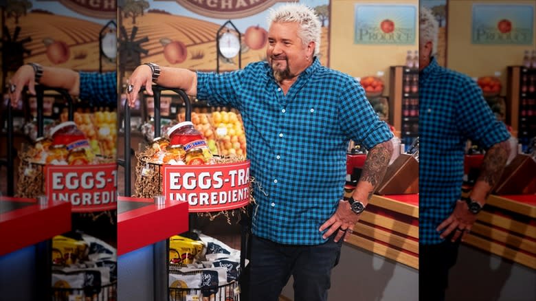 Guy Fieri standing by an egg display