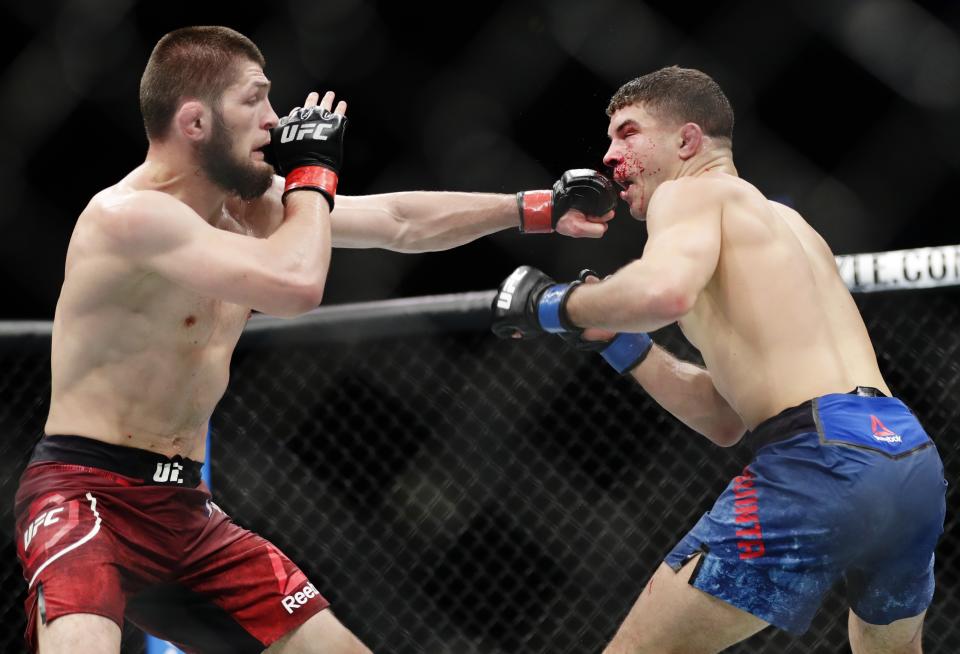 Russia’s Khabib Nurmagomedov (L) punches Al Iaquinta during the third round of a lightweight title bout at UFC 223 early Sunday, April 8, 2018, in New York. Nurmagomedov won the fight. (AP)