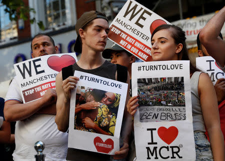 People hold placards in St Ann's Square, in central Manchester, Britain May 26, 2017. REUTERS/Stefan Wermuth