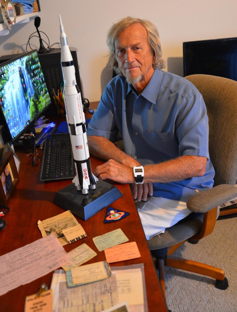 Bob Freeman in the office of his Melbourne home, with a Saturn V model on his desk. He worked on the Apollo program from 1967-69.