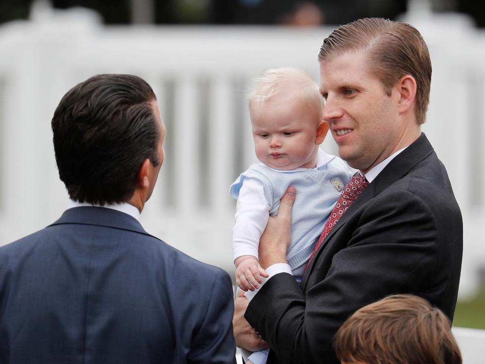 Eric Trump, left, holding son Luke, during the annual White House Easter Egg Roll on the South Lawn of the White House in Washington, Monday, April 2, 2018.