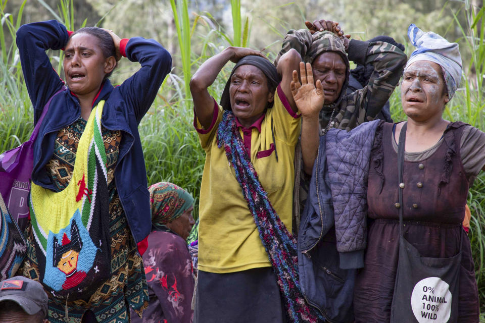 In this photo released by UNDP Papua New Guinea, villagers react as they search through a landslide in Yambali village, in the Highlands of Papua New Guinea, Monday, May 27, 2024. Authorities fear a second landslide and a disease outbreak are looming at the scene of Papua New Guinea's recent mass-casualty disaster because of water streams trapped beneath tons of debris and decaying corpses seeping downhill following the May 24 landslide. (Juho Valta/UNDP Papua New Guinea via AP)