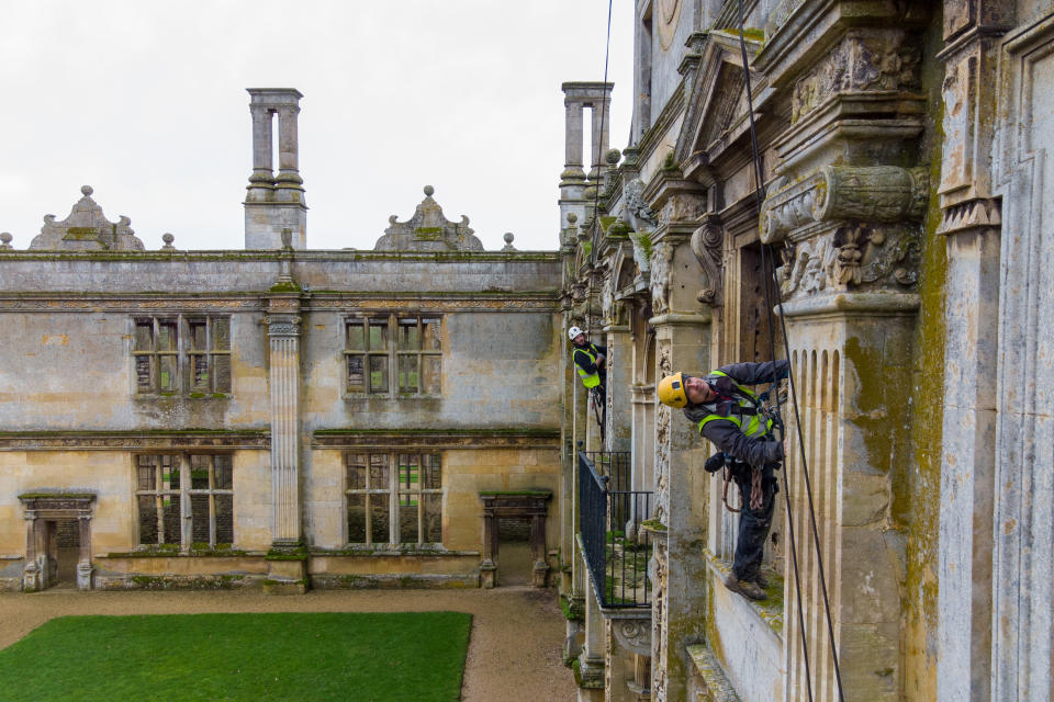 <p>Stonemasons John Fowler and James Preston from SSH Conservation survey Kirby Hall in Corby, Northamptonshire, as English Heritage prepares to carry out vital conservation work. Picture date: Tuesday February 16, 2021.</p>
