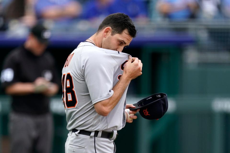 Detroit Tigers starting pitcher Matthew Boyd wipes away sweat after giving up a pair of runs during the first inning of a baseball game against the Kansas City Royals Saturday, May 22, 2021, in Kansas City, Mo.