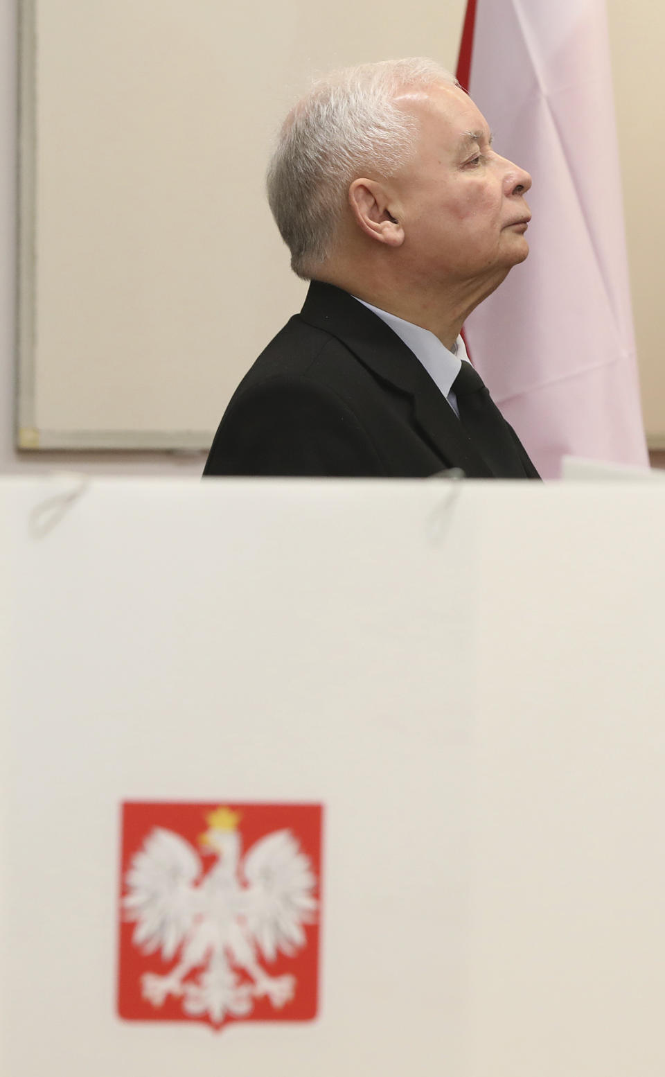 The ruling party leader Jaroslaw Kaczynski holds his ballot at a polling station in Warsaw, Poland, Sunday, Oct. 13, 2019. Poles are voting Sunday in a parliamentary election that Kaczynski is favored to win easily, buoyed by the popularity of its social conservatism and generous social spending policies that have reduced poverty. (AP Photo/Czarek Sokolowski)