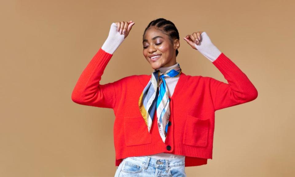 A woman wearing a red knitted cardigan