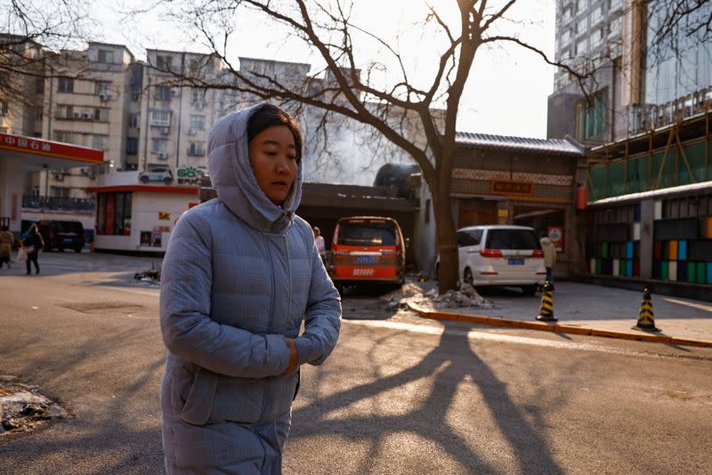 Woman walks on a street on a cold winter day in Beijing