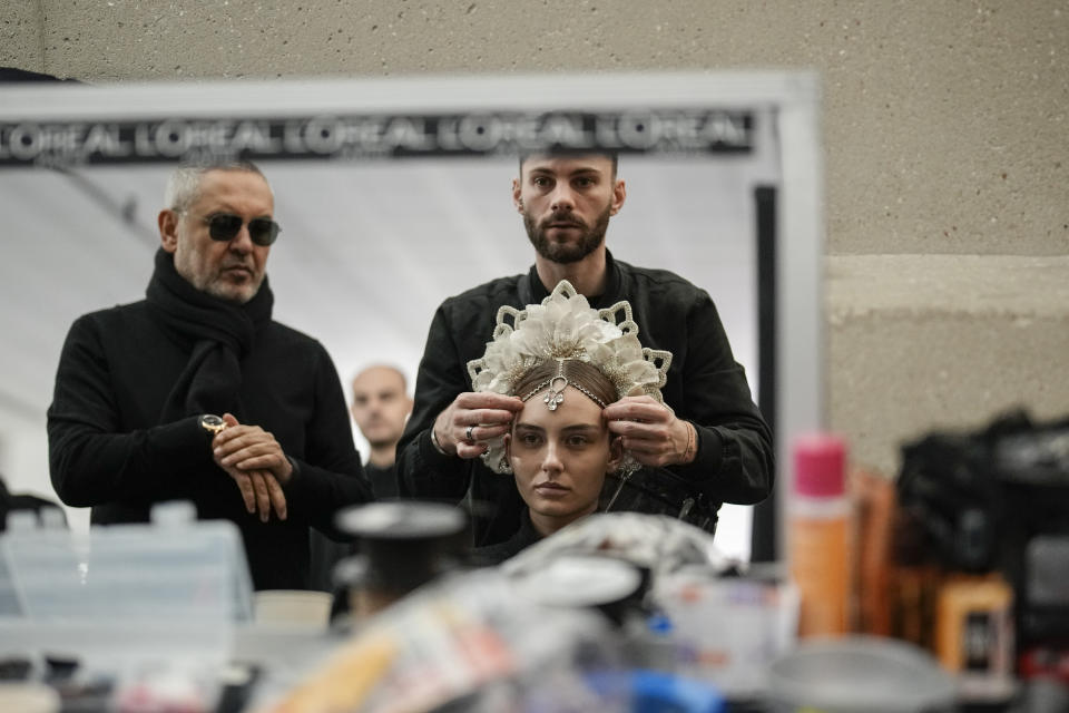 A model is seen preparing backstage before the Elie Saab Haute Couture Spring-Summer 2023 collection presented in Paris, Wednesday, Jan. 25, 2023. (AP Photo/Christophe Ena)