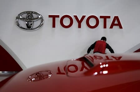 FILE PHOTO: An employee works under a Toyota Motor Corp logo at the company's showroom in Tokyo