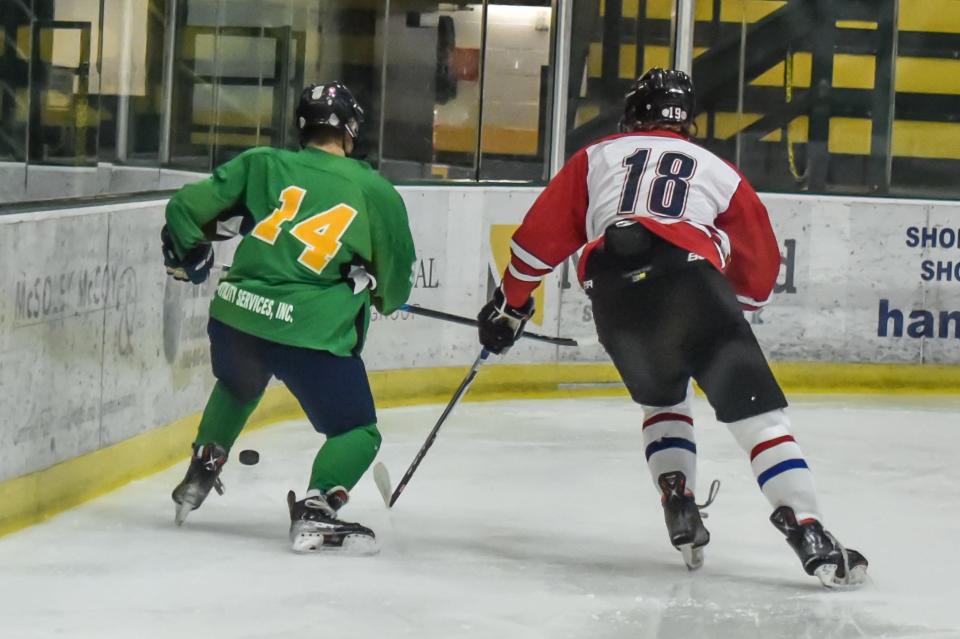 Vermont's Alex Brown and New Hampshire's Maddox Muir race for the puck during their 5-2 loss to New Hampshire in the Make-A-Wish All-Star Hockey Classic between the two states on Saturday afternoon at UVM's Gutterson Fieldhouse.