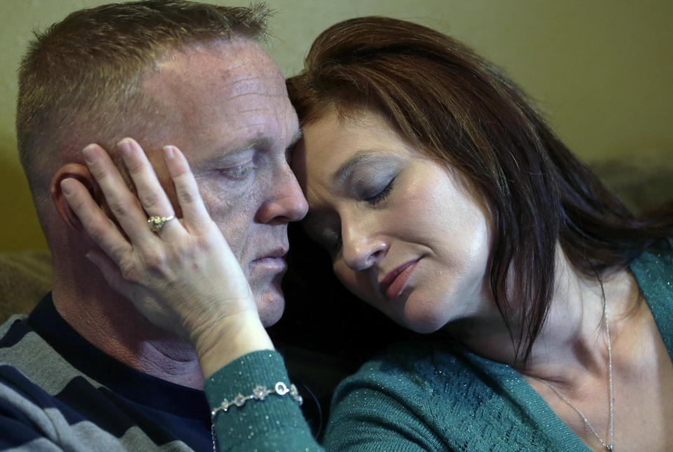 In this Friday, Jan. 10, 2014 photo, Jessica McAllister comforts her husband Kainan McAllister during an interview with The Associated Press in Chalmette, La. Kainan is the brother of Denise Freeman, the first victim in the killing spree at the hands of her husband, Benjamin Freeman. he shootings stunned the bayou community 50 miles southwest of New Orleans. Investigators, victims and grieving family members don’t know exactly what set off Freeman’s rampage. But the shootings raised concerns about whether Louisiana law provides adequate safeguards to keep guns away from troubled people. (AP Photo/Gerald Herbert)