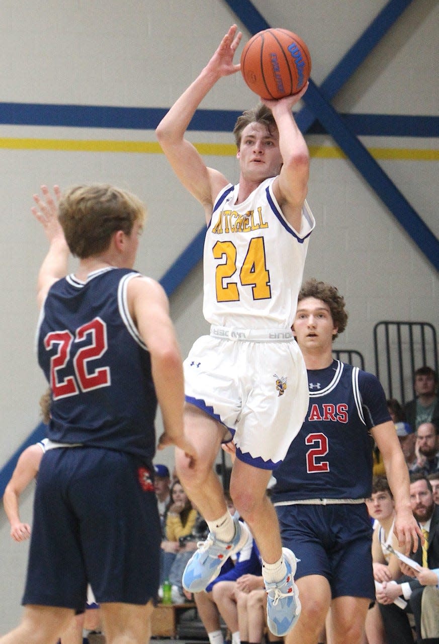 Mitchell's Nick Mundy fires a jump shot over BNL's Colton Staggs (22) Tuesday night at The Hive.