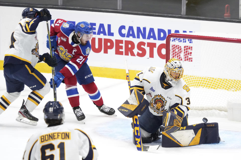 Edmonton Oil Kings' Jake Neighbours, second from left, watches as a goal is scored on Shawinigan Cataractes goaltender Charles-Antoine Lavallee during the first period of the Memorial Cup hockey game in Saint John, New Brunswick, Tuesday, June 21, 2022. (Darren Calabrese/The Canadian Press via AP)