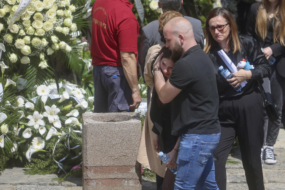 People mourn during the funeral procession of a girl Ema Kobiljski,13, at the central cemetery in Belgrade, Serbia, Saturday, May 6, 2023. Her schoolmate, a 13-year-old boy, on Wednesday, used his father's guns to kill eight fellow students and a guard. (AP Photo/Armin Durgut)