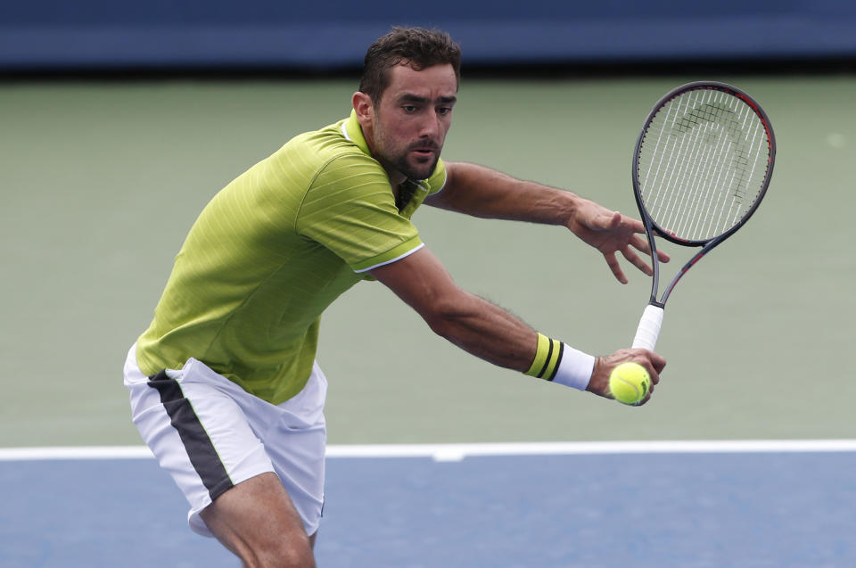 Marin Cilic, of Croatia, returns a backhand against Radu Albot, of Moldova, during first round play at the Western & Southern Open tennis tournament, Monday, Aug. 12, 2019, in Mason, Ohio. (AP Photo/Gary Landers)