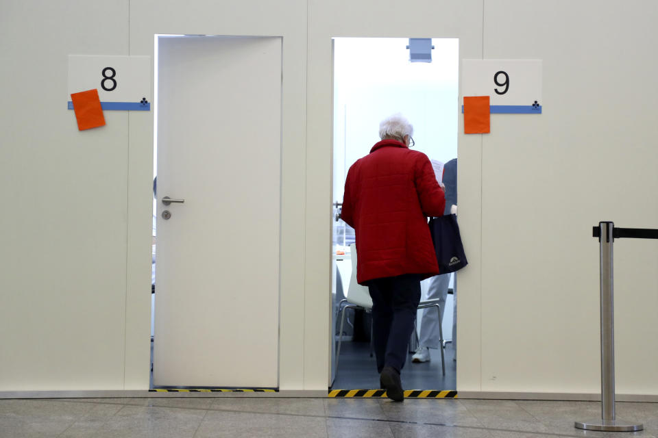 An elderly woman enters a doctors room for her vaccination at a local vaccination centre as the spread of the coronavirus disease (COVID-19) continues in Ebersberg near Munich, Germany, Monday, March 22, 2021. (AP Photo/Matthias Schrader)
