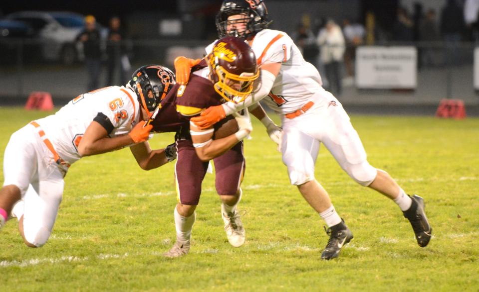 Plainfield's Will Kotcher, left, and Connor Stamper bring down Tiverton's Roman Fauci during the Panthers' 29-14 win Friday night at Plainfield High School.