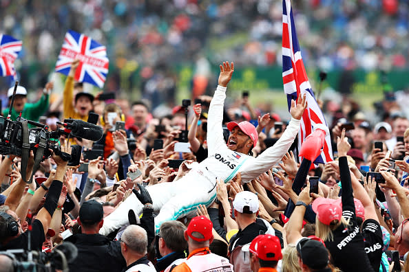 Lewis Hamilton celebrates with fans after the F1 Grand Prix of Great Britain at Silverstone in 2019.