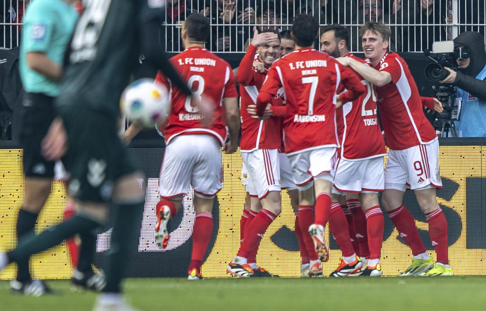 Union Berlin players celebrate after Vertessen's goal during the Bundesliga soccer match between 1. FC Union Berlin and Werder Bremen in Berlin, Germany, Saturday March 16, 2024. (Andreas Gora/dpa via AP)