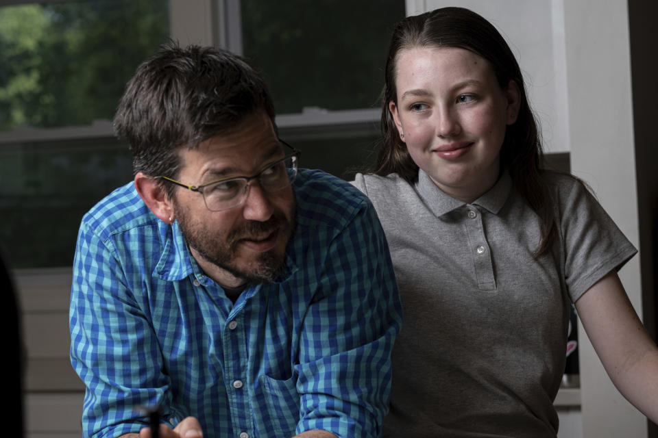 Jay Wamsted, left, and his daughter, Kira, are photographed on Thursday, May 20, 2021 in Smyrna, Ga. Wamsted, who is an 8th grade math teacher, allowed his daughter to skip testing this year. With new flexibility from the Biden administration, states are adopting a patchwork of testing plans that aim to curb the stress of exams while still capturing some data on student learning. (AP Photo/Ben Gray)