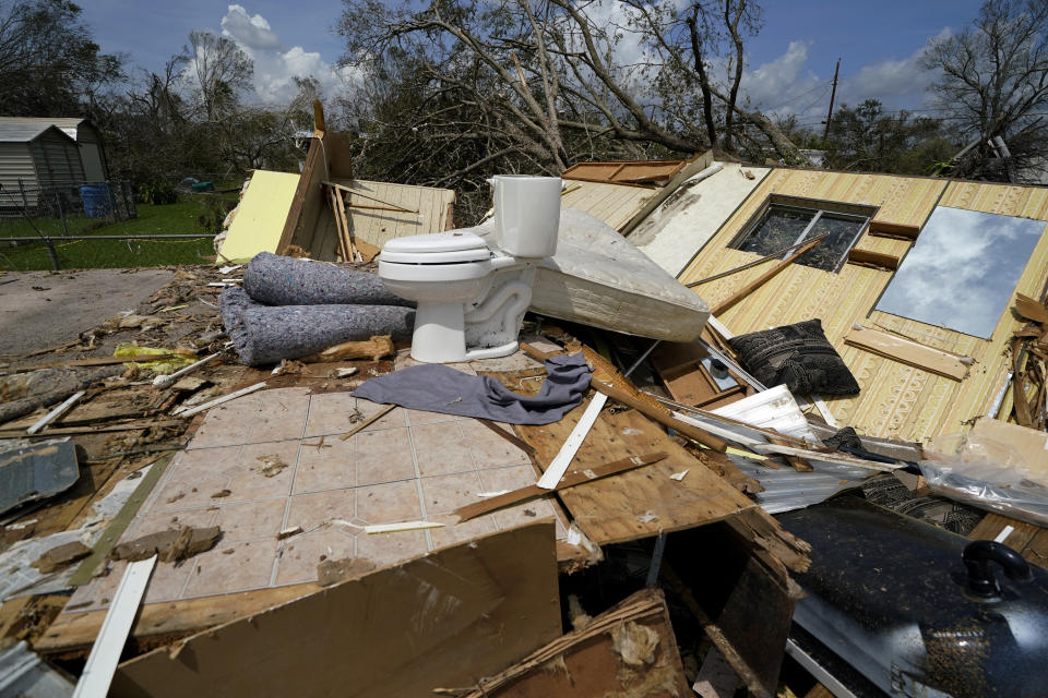 Remnants of the half destroyed mobile home of James Towfley, who is living in the standing half, are seen in Lake Charles, La., in the aftermath of Hurricane Laura, Sunday, Aug. 30, 2020. (AP Photo/Gerald Herbert)