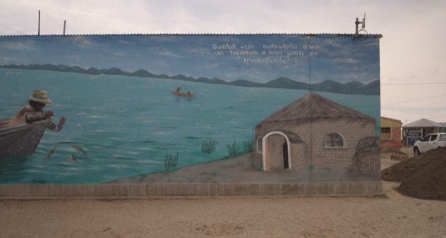 A wall painting of Uru Indigenous person fishing Lake Poopo. (AFP)
