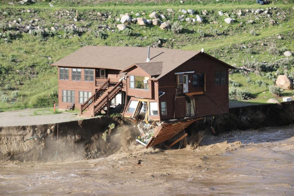 The 2022 Yellowstone flood inundated communities and swiftly eroded the land beneath this cabin that housed park employees. <a href="https://www.flickr.com/photos/yellowstonenps/52146801150" rel="nofollow noopener" target="_blank" data-ylk="slk:Gina Riquier via National Park Service;elm:context_link;itc:0;sec:content-canvas" class="link ">Gina Riquier via National Park Service</a>
