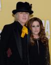 WORST: Lisa Marie Presley's husband Michael Lockwood wore this bright yellow tie and velvet hat.