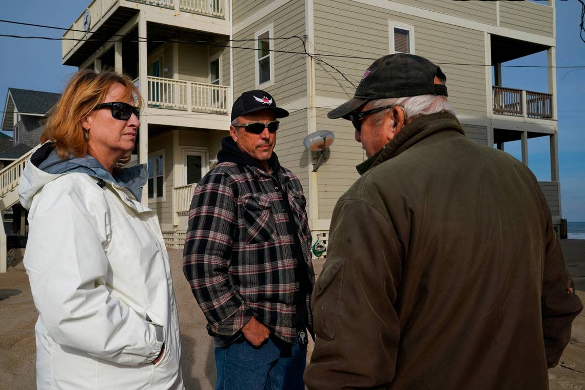 The Urbans chat with Outer Banks resident Carroll Midgett Sr. as they assess storm damage.