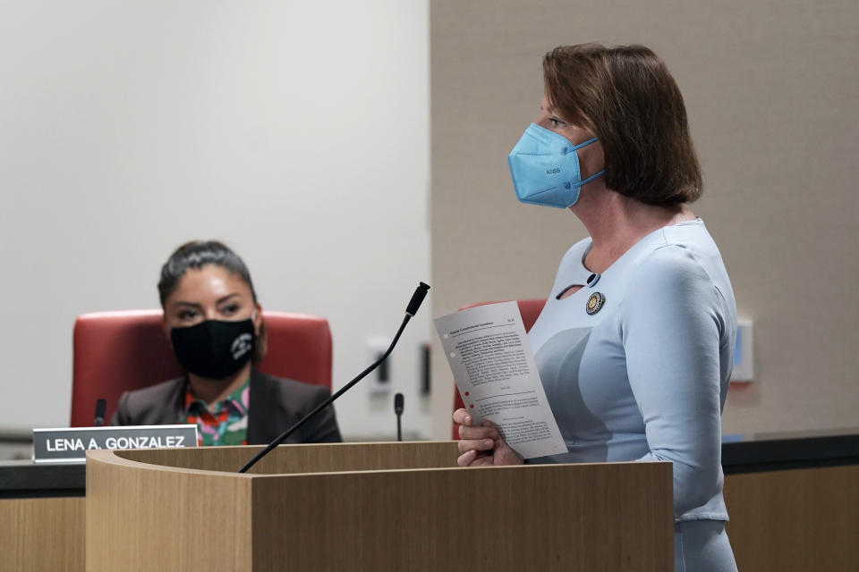 State Sen. President Pro Tempore Toni Atkins, right, displays a copy of her proposed amendment to the state constitution that would protect the right to an abortion and contraceptives during a hearing on the measure in Sacramento, Calif., Tuesday, June 14, 2022. The bill was approved by two legislative committees. It must get a two-thirds vote in the state Assembly and Senate before June 30 to qualify for the November ballot. (AP Photo/Rich Pedroncelli)