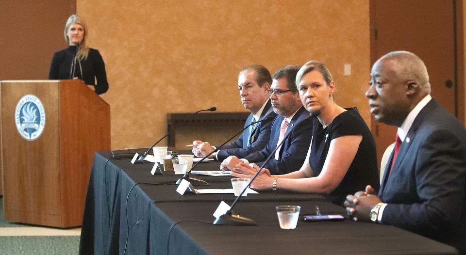 State Rep. Webster Barnaby, right, speaks at a breakfast April 14 in Daytona Beach, as fellow lawmakers including Rep. Elizabeth Fetterhoff listen.