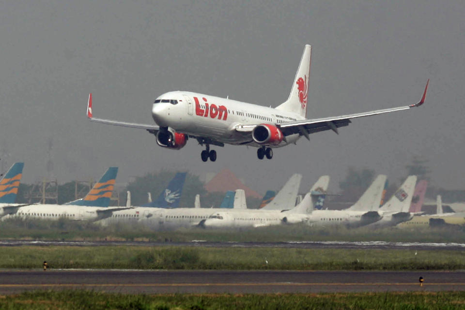 FILE - In this May 12, 2012 file photo, a Lion Air passenger jet takes off from Juanda International Airport in Surabaya, Indonesia. Indonesia's top discount carrier Lion Air, which catapulted into the global aviation spotlight with record deals to buy Airbus and Boeing planes, is taking the battle for Asia’s budget-minded travelers to the backyard of the airline that helped pioneer low cost flights in the region. (AP Photo/Trisnadi, File)