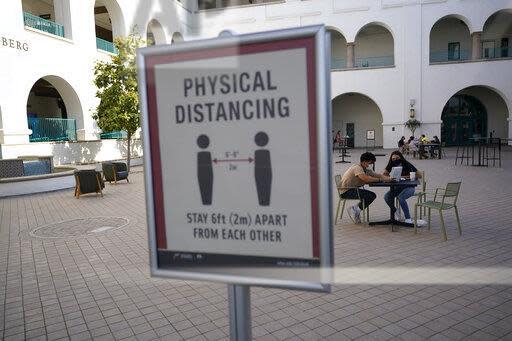 San Diego State University halted in-person classes Wednesday after dozens of students were infected with the coronavirus.