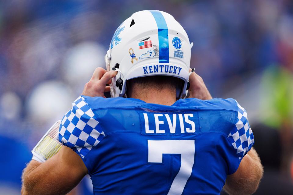 Kentucky quarterback Will Levis puts on his helmet before an NCAA college football game against Vanderbilt in Lexington, Ky., Saturday, Nov. 12, 2022. (AP Photo/Michael Clubb)