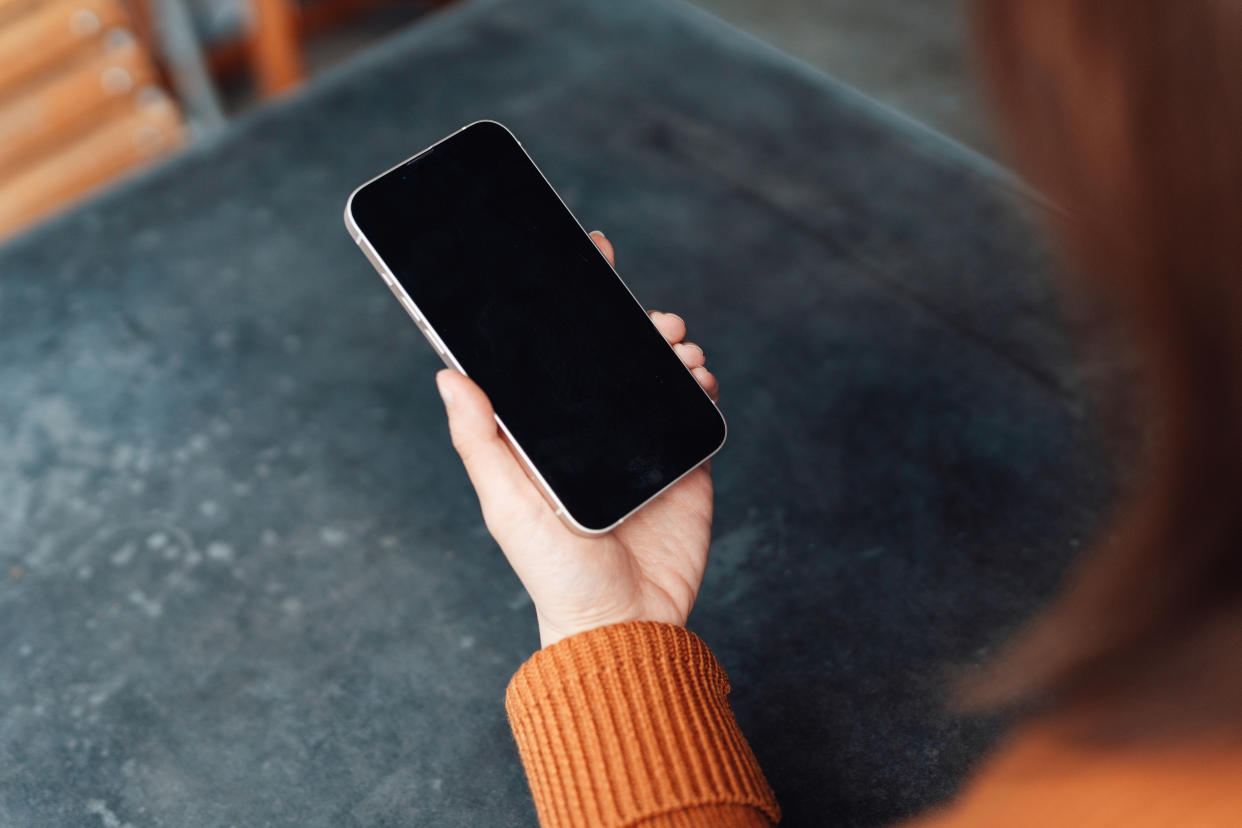 Mockup image of female hand using smartphone with blank screen. Mobile banking and personal finance.